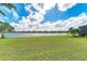 Expansive backyard with lush green lawn and scenic lake views at 6547 Willowshire Way, Bradenton, FL 34212