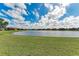 Beautiful backyard with a large lake and well-maintained lawn, perfect for outdoor enjoyment at 6547 Willowshire Way, Bradenton, FL 34212