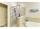 Bathroom features a tiled walk-in shower, soaking tub, and tile surround at 6547 Willowshire Way, Bradenton, FL 34212