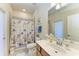 Bright bathroom with a walk-in shower, vanity, and nautical-themed decor at 6547 Willowshire Way, Bradenton, FL 34212
