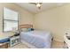 Bedroom features a ceiling fan, large window, and side tables at 6547 Willowshire Way, Bradenton, FL 34212