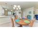 Open dining area with wood table, pendant lighting, and view to the kitchen at 6547 Willowshire Way, Bradenton, FL 34212