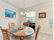 Bright dining area with a round table, natural light, and neutral decor at 6547 Willowshire Way, Bradenton, FL 34212