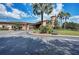 Inviting building entrance with golf cart parking, lush landscaping, and covered entryway at 6547 Willowshire Way, Bradenton, FL 34212