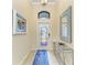 Bright entryway with decorative mirror, a glass door, and blue accents, creating a welcoming ambiance at 6547 Willowshire Way, Bradenton, FL 34212