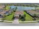 Charming single-Gathering home with tile roof, two car garage, brick driveway, and lush tropical landscaping at 6547 Willowshire Way, Bradenton, FL 34212