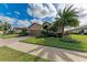 Well-kept front exterior with a brick driveway, lush lawn, and beautiful landscaping, enhancing its charm at 6547 Willowshire Way, Bradenton, FL 34212