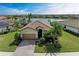 Charming home featuring a tile roof, a well-manicured lawn, and lush landscaping, providing great curb appeal at 6547 Willowshire Way, Bradenton, FL 34212