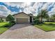 Beautiful home with a brick driveway, lush lawn, and manicured landscaping, providing great curb appeal at 6547 Willowshire Way, Bradenton, FL 34212