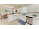 Bright kitchen features white cabinets, stainless steel appliances, and tile backsplash at 6547 Willowshire Way, Bradenton, FL 34212