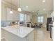 Modern kitchen featuring white cabinets, quartz countertops, and a stylish tile backsplash, ideal for cooking at 6547 Willowshire Way, Bradenton, FL 34212