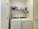 Convenient laundry room with washer, dryer, and shelving for organized storage at 6547 Willowshire Way, Bradenton, FL 34212