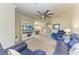 Spacious living room with entertainment center and comfortable blue seating area at 6547 Willowshire Way, Bradenton, FL 34212