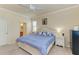 Comfortable main bedroom features a ceiling fan, soft carpet and ensuite bathroom at 6547 Willowshire Way, Bradenton, FL 34212