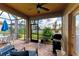 Screened patio with brick flooring, grill, ceiling fan, and serene water views at 6547 Willowshire Way, Bradenton, FL 34212