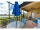 Relaxing screened patio with table, chairs, grill, and scenic lake views for outdoor enjoyment at 6547 Willowshire Way, Bradenton, FL 34212