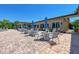 Outdoor patio with tables, chairs, and umbrellas, perfect for dining and relaxation by the pool at 6547 Willowshire Way, Bradenton, FL 34212