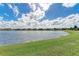 A beautiful water view showcases waterfront homes under a partly cloudy sky at 6547 Willowshire Way, Bradenton, FL 34212