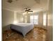 Bright bedroom featuring a king-size bed and tile flooring at 6935 74Th Street E Cir, Bradenton, FL 34203