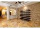 Open living room with a stone accent wall, shelving, and tile flooring at 6935 74Th Street E Cir, Bradenton, FL 34203