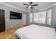 Spacious bedroom with a king-size bed and mounted TV at 6935 74Th Street E Cir, Bradenton, FL 34203