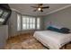 Spacious bedroom with a king-size bed and window shutters at 6935 74Th Street E Cir, Bradenton, FL 34203