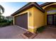 Attached two-car garage with brown door at 6935 74Th Street E Cir, Bradenton, FL 34203