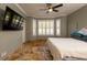 Spacious bedroom with a king-size bed and mounted TV at 6935 74Th Street E Cir, Bradenton, FL 34203