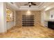 Living room with a tile floor, stone feature wall, and built-in shelving at 6935 74Th Street E Cir, Bradenton, FL 34203