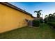 Side view of house showing AC unit and yard at 6935 74Th Street E Cir, Bradenton, FL 34203