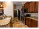 Kitchen with wood cabinets, granite countertops, and stainless steel appliances at 6935 74Th Street E Cir, Bradenton, FL 34203