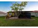 Backyard view of house with pergola and screened patio at 6935 74Th Street E Cir, Bradenton, FL 34203