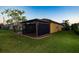 Side of house with screened patio and landscaping at 6935 74Th Street E Cir, Bradenton, FL 34203