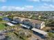 Aerial view of the condo complex surrounded by trees and lake at 7201 29Th Avenue W Dr # 309, Bradenton, FL 34209