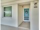 Condo entry with teal door and small welcome mat at 7201 29Th Avenue W Dr # 309, Bradenton, FL 34209