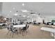 Large community room with tables, chairs, and neutral carpeting at 7201 29Th Avenue W Dr # 309, Bradenton, FL 34209