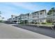 Exterior of condo building with carports, well-maintained landscaping, and ample parking at 7201 29Th Avenue W Dr # 309, Bradenton, FL 34209