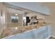 Modern kitchen bar with granite countertop, stainless steel appliances, and views into the dining area at 7201 29Th Avenue W Dr # 309, Bradenton, FL 34209