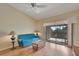 Cozy living room with comfortable seating, ceiling fan, and sliding doors to private balcony at 7201 29Th Avenue W Dr # 309, Bradenton, FL 34209