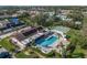 Aerial view of a community pool, lawn bowling, clubhouse, and condos with solar panels on the roof at 7201 29Th Avenue W Dr # 309, Bradenton, FL 34209