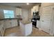 Bright kitchen with stainless steel appliances and an island at 890 Indus Rd, Venice, FL 34293