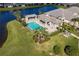 Community pool and clubhouse with lake view at 3127 Trustee Ave, Sarasota, FL 34243