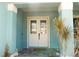 Inviting home exterior with a double door entry and light teal color at 716 Laurel Ave, Venice, FL 34285