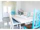 Farmhouse style dining table with blue chairs and a light gray floor at 716 Laurel Ave, Venice, FL 34285