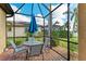 Enjoy outdoor dining in this screened patio, complete with table, chairs, and umbrella at 6547 Willowshire Way, Bradenton, FL 34212