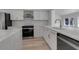Modern kitchen with white cabinets, quartz countertops and a large island at 2303 89Th Nw St, Bradenton, FL 34209