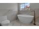 Relaxing bathroom with a free-standing tub, marble tile, and a large window at 2303 89Th Nw St, Bradenton, FL 34209