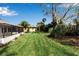 Spacious backyard with a large lawn and lush landscaping at 2303 89Th Nw St, Bradenton, FL 34209