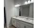 Elegant bathroom with double vanity and a large mirror at 890 Indus Rd, Venice, FL 34293