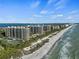 Expansive aerial view of beachfront property and resort amenities at 1241 Gulf Of Mexico Dr # 708, Longboat Key, FL 34228
